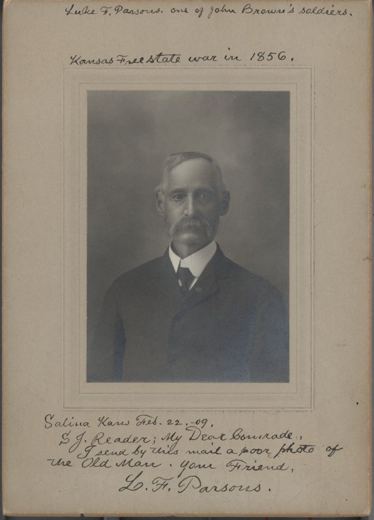 Portrait of Luke F. Parsons taken on Feb. 22, 1909. Image courtesy of Kansas Historical Society. Parsons is facing the viewer. Sepia tone photograph.